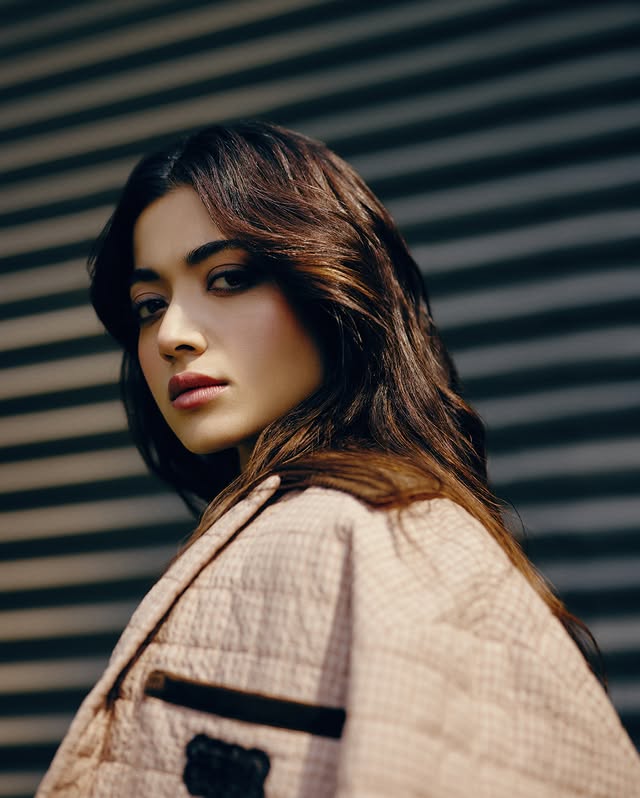 Instagram post by @rashmika_mandanna for Onitsuka Tiger. Caption reads: [...] moment 🤍 So excited to celebrate Onitsuka....