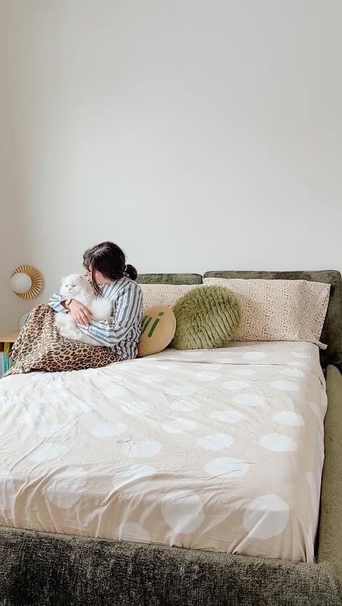 Instagram post by @hey.maca for Cozey. Caption reads: World, meet my new @cozey Ara bed - she’s my....