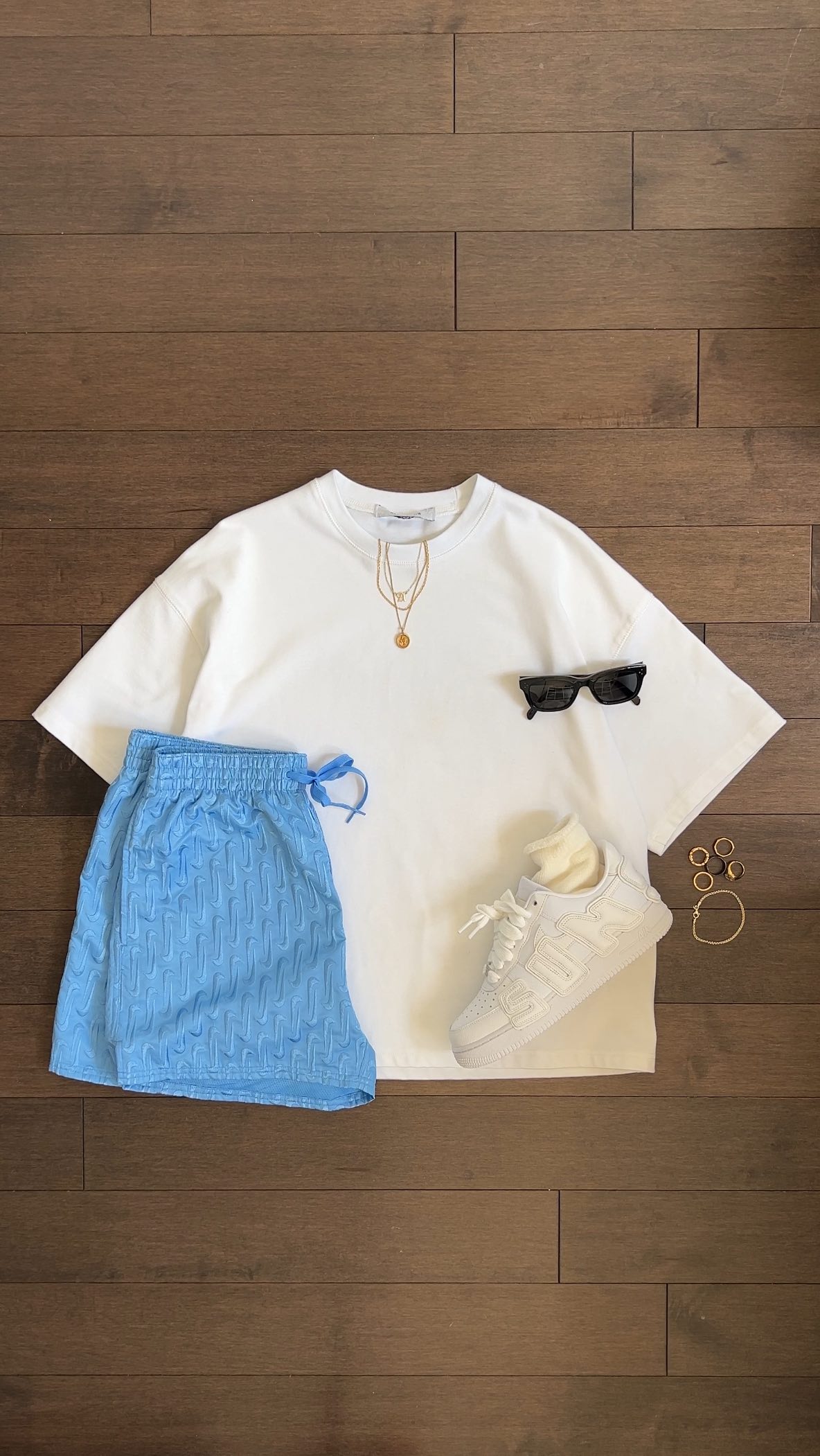 Instagram post by @omgessin for Nike Swim. Caption reads: simple beach outfits with @nikeswim ☀️....