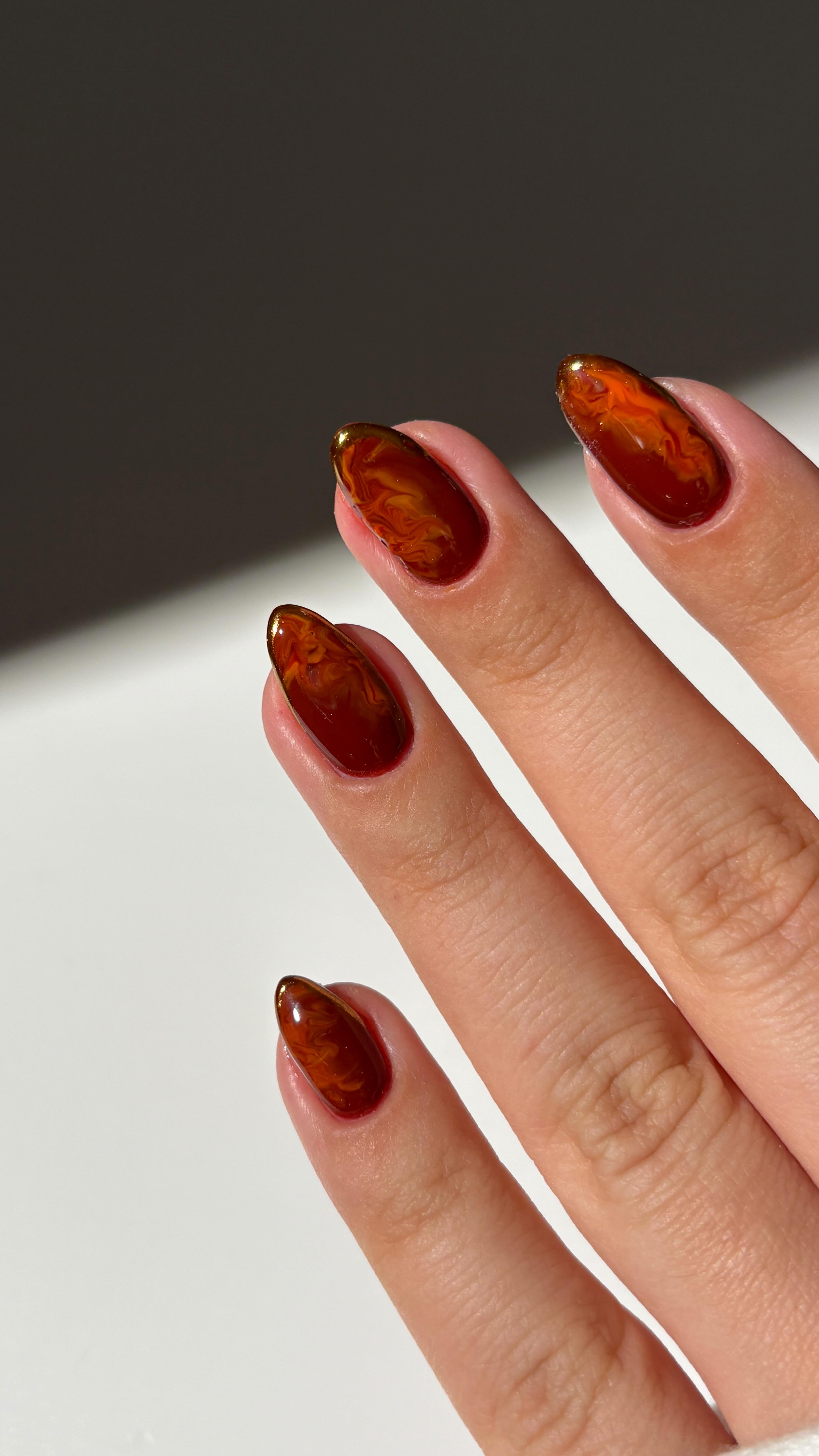 Instagram post by @simlynail for Modelones. Caption reads: ad• autumn marble and gold chrome combo🤎✨ 

using....