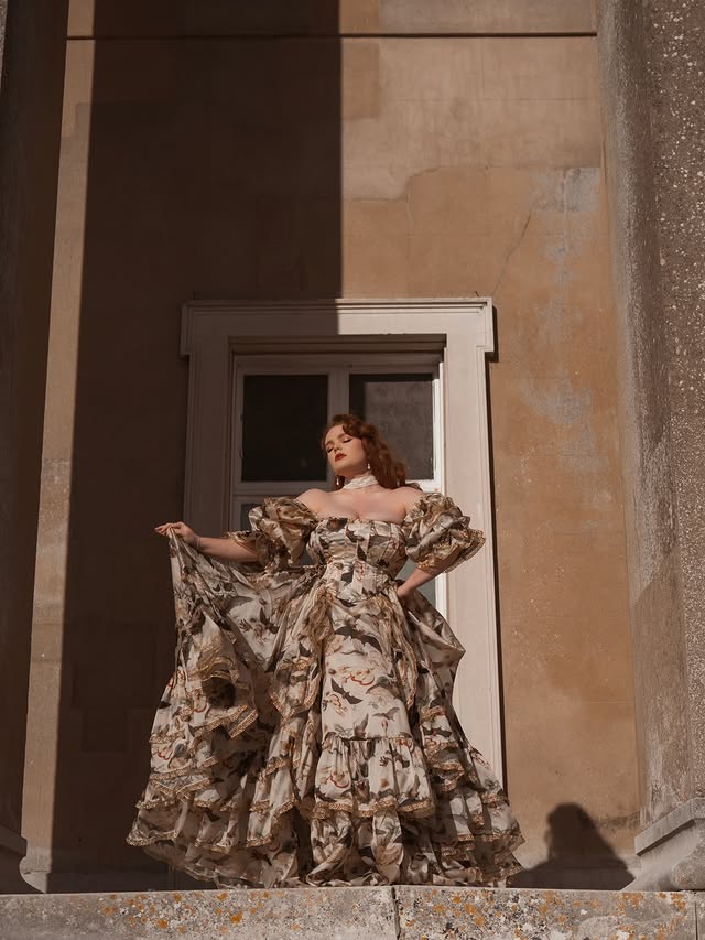 Instagram post by @missdeadlyred for Selkie. Caption reads: Bats and flowers 🦇 🥀 Dress- @selkie (gifted) -....