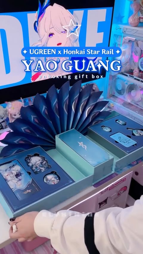 Instagram post by @elyxirine for UGREEN. Caption reads: ✦💙 unboxing Yao Guang x UGREEN exclusive box 🦚✨....