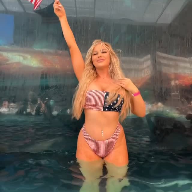 Instagram post by @ivy_ferguson for AMICLUBWEAR. Caption reads: Red, white, and finally mine 🇺🇸 celebrating my....