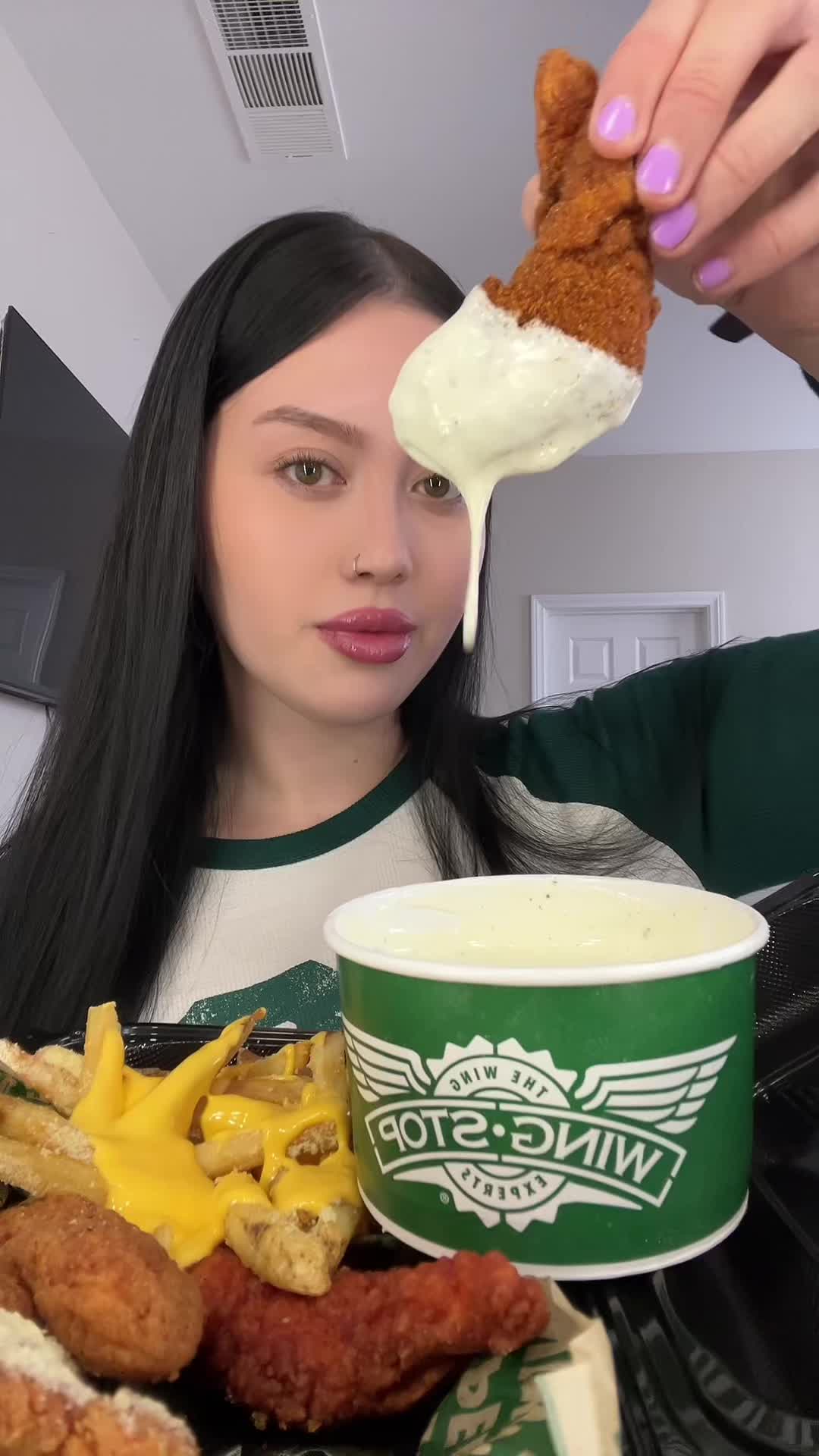 TikTok post by @nessieatss for Wingstop. Caption reads: WINGSTOP MUKBANG ASMR 💚  @Wingstop tenders, fries....