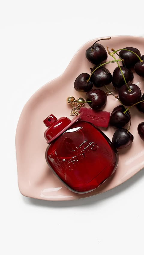 Instagram post by @cindyvdgraaf for Coach. Caption reads: [...] my cherry bag! 🍒 ft. the new fragrance....