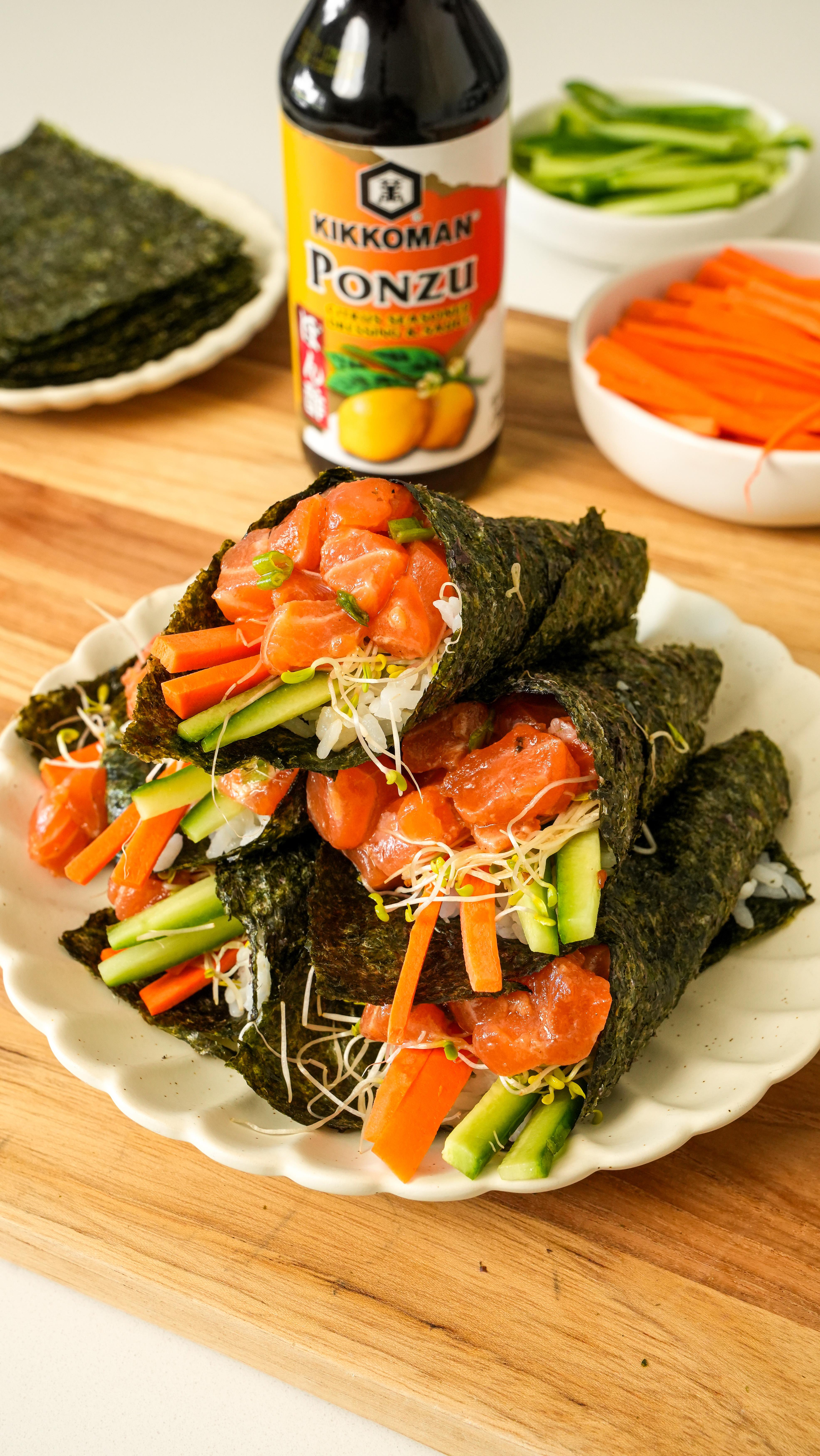 Instagram post by @onehappybite for Kikkoman USA. Caption reads: These Ponzu Salmon Hand Rolls are filled with....