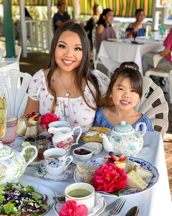 Instagram post by @yumi_doll for Jeans Warehouse Hawaii. Caption reads: There’s always time for a spot of tea! SWIPE for....