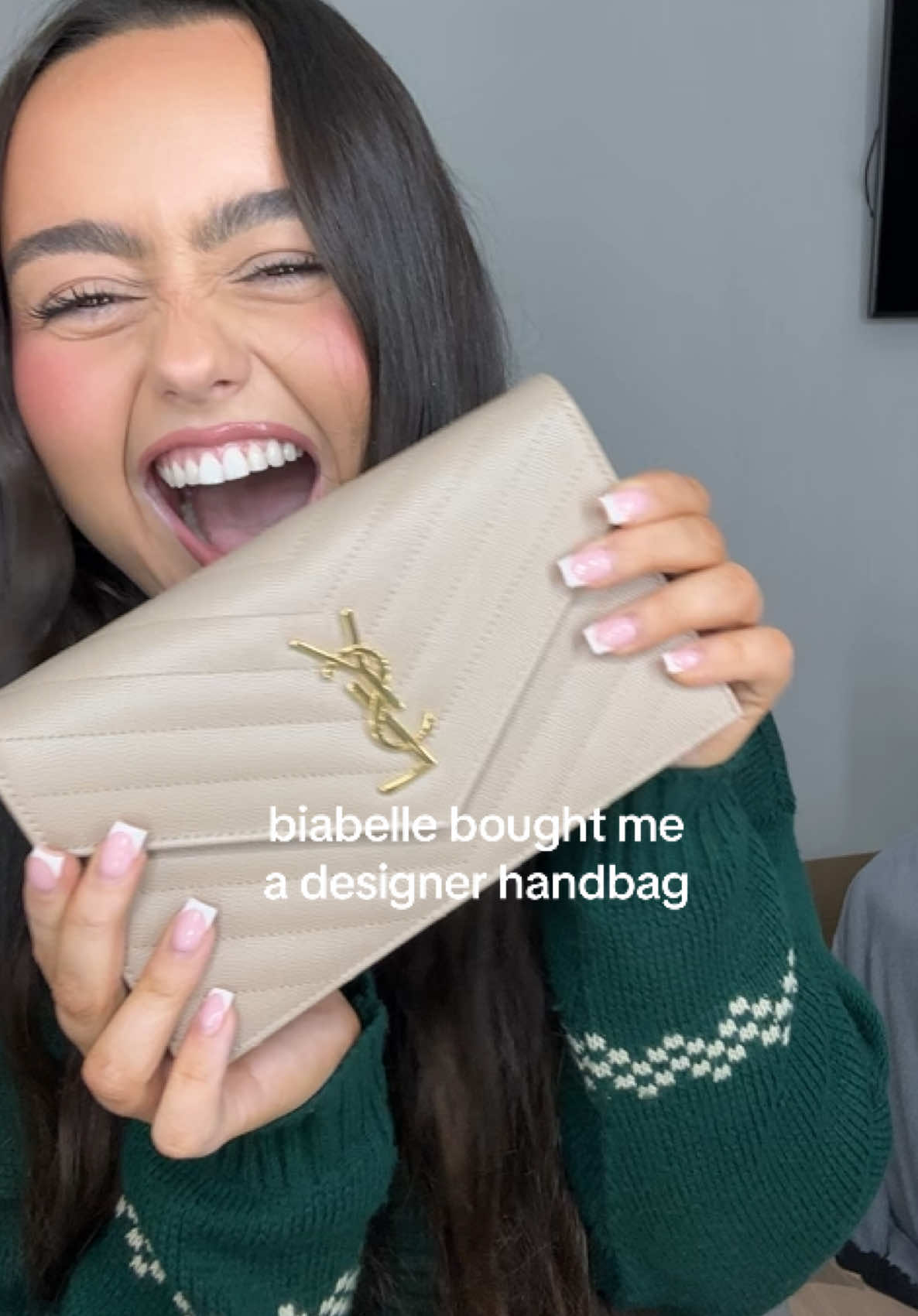 TikTok post by @_hannahmclean for BiaBelle Beauty. Caption reads: @BiaBelle bought me a YSL handbag 😢💫🎄 ....