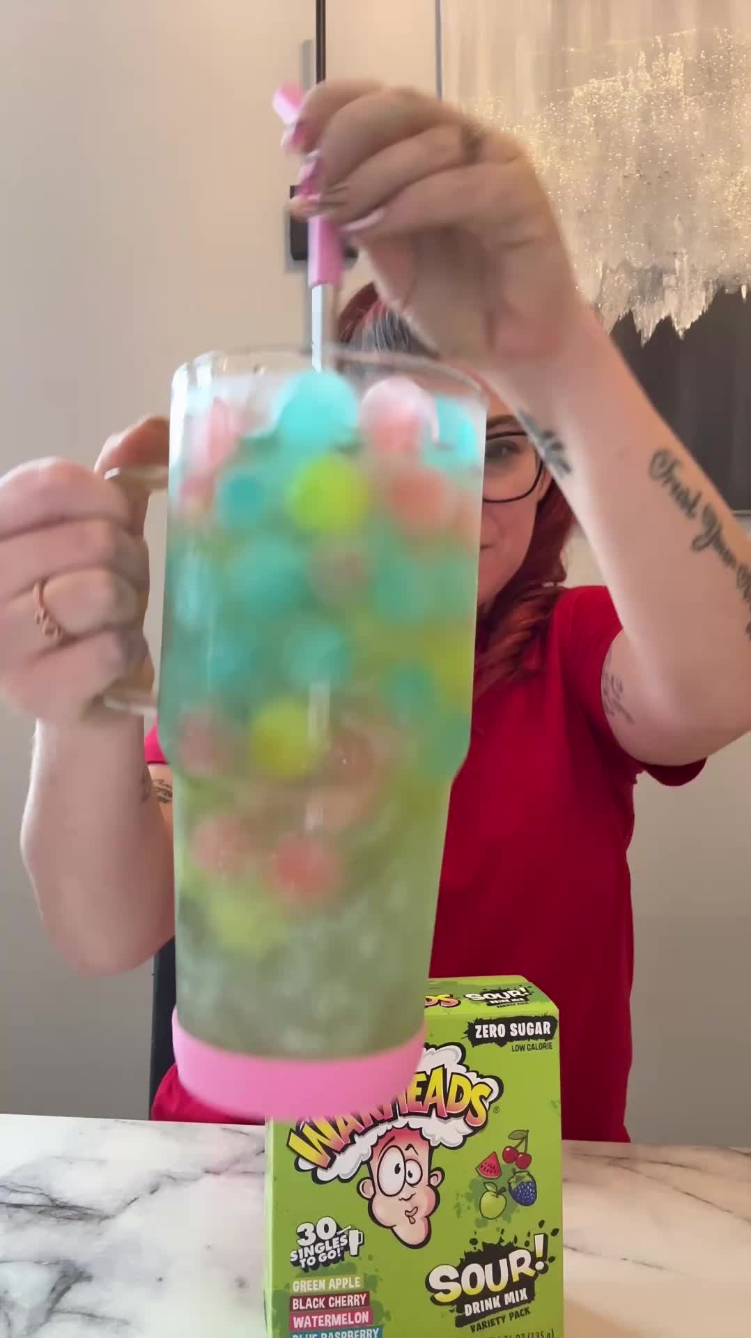 TikTok post by @soflofooodie for Singles To Go. Caption reads: 💥 Sour fairy water incoming 🍋 The drink aisle at....