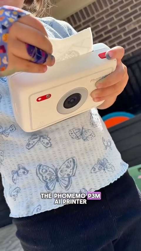 Instagram post by @cozy_craft_mama for Phomemo. Caption reads: The Phomemo 3PM AI Printer Camera from [...].