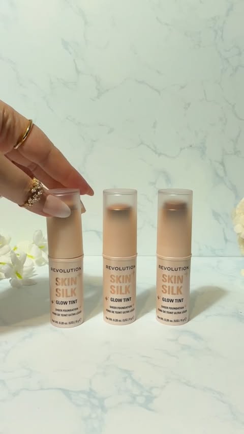 Instagram post by @glambyghiz for Makeup Revolution. Caption reads: Introducing Skin Silk Glow Tint, an illuminating....