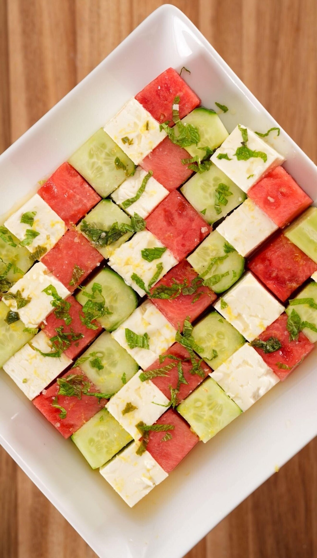 Instagram post by @brandongouveia for Buzzfeed. Caption reads: Watermelon, cucumber, and feta salad is summer on....