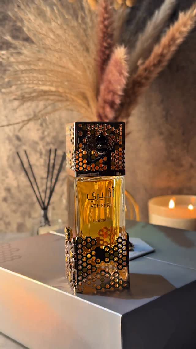 Instagram post by an influencer for Lattafa Perfumes. Caption reads: ATHEERI 🐝✨@lattafa_perfumes Top Notes:....
