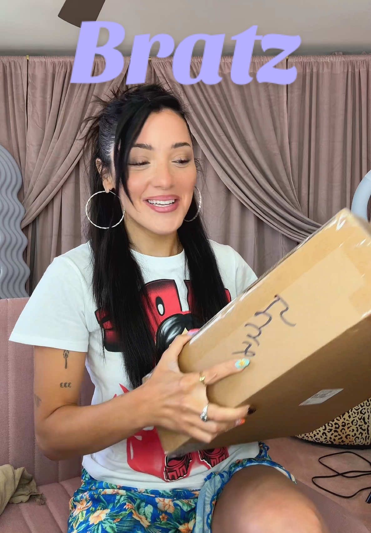 TikTok post by @nikidemar for Bratz. Caption reads: screaming @bratz 🎸💜 for more content, check out....