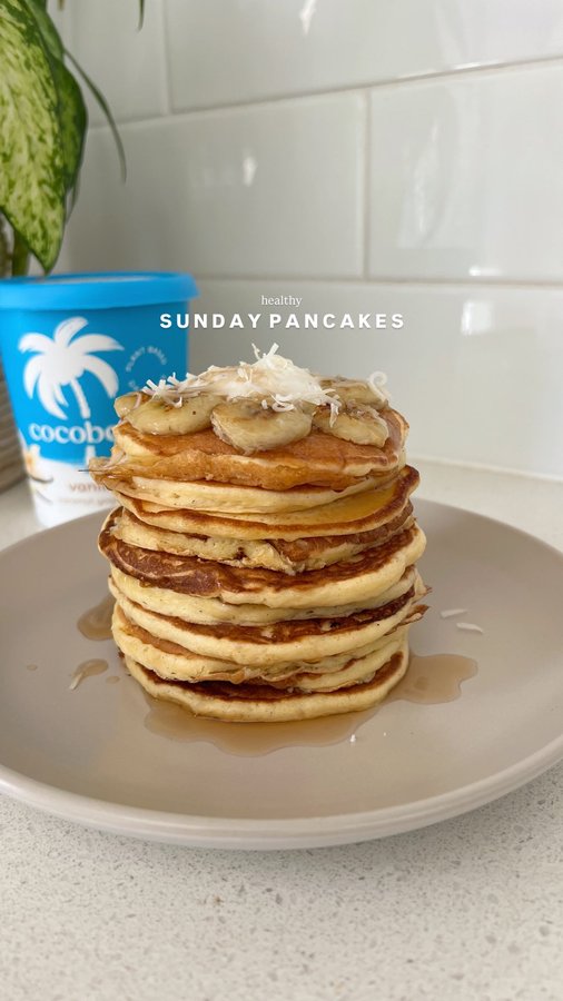 Instagram post by @nutrition.by.kayla for Cocobella. Caption reads: WHOLESOME SUNDAY PANCAKES 🥞🥥🍯

Made with....