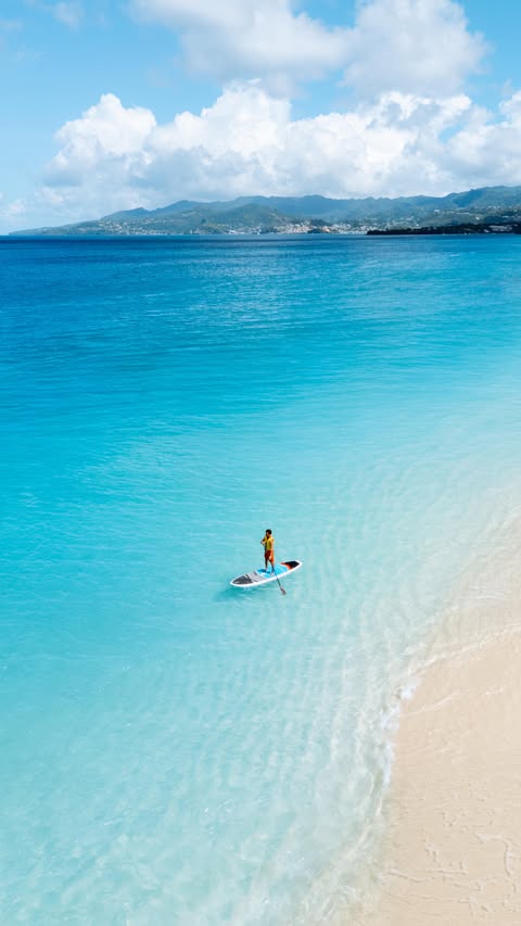 Instagram post by @allaboutwanderlust_ for Sandals Resorts. Caption reads: [...] island of Grenada 🇬🇩 where @sandalsresorts....