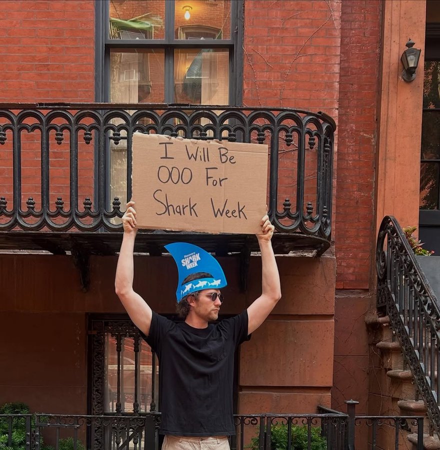 Instagram post by @dudewithsign for Discovery. Caption reads: [...] text me July 20-July 26. #SharkWeek on....