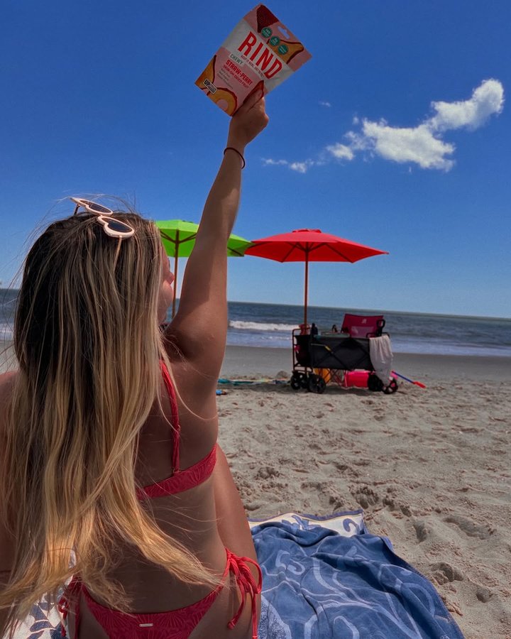 Instagram post by @emilysentnerr for RIND Snacks. Caption reads: my go to snack all summer @rindsnacks
.
use code....