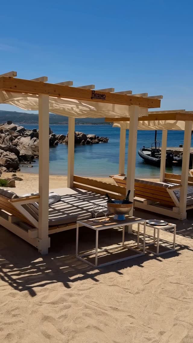 Instagram post by @phibeachofficial for Herno. Caption reads: Shaded by design, touched by the sea breeze 🌊
The....