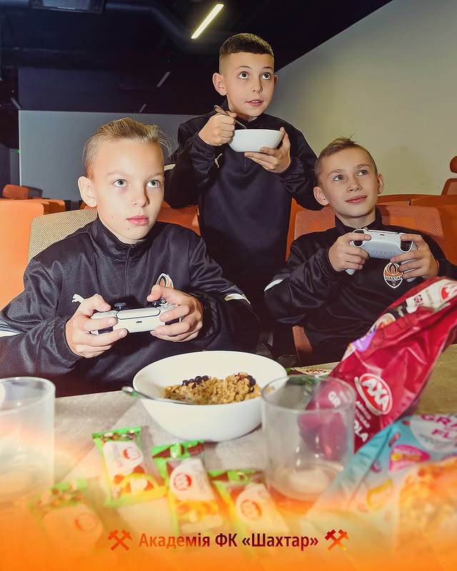Instagram post by @fcshakhtar for AXA. Caption reads: [...] games, laughter and a new snack from AXA –....