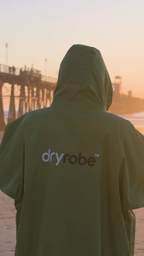 Instagram post by @logan_kamen for dryrobe. Caption reads: My Dryrobe Advance is with me every time I surf in....