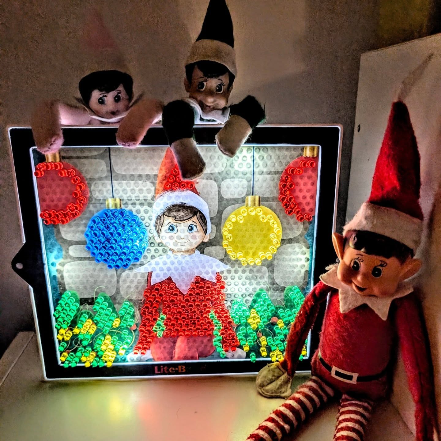 Instagram post by @toby_and_the_twins16 for Basic Fun!. Caption reads: AD| The Elf on the Shelf Lite-Brite has been such....