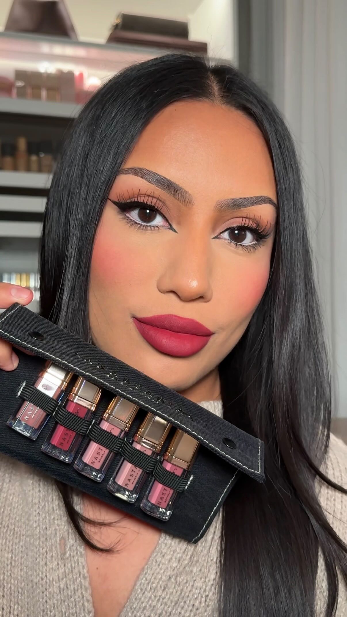 Instagram post by @elizmmakeup for Anastasia Beverly Hills. Caption reads: cranberry red lips — using @anastasiabeverlyhills....