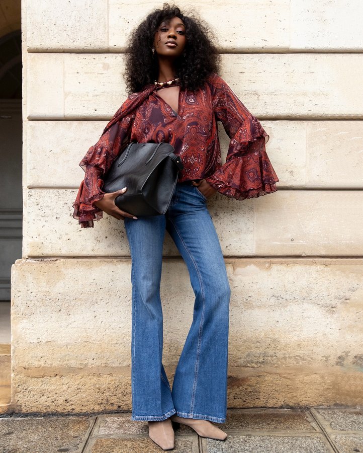 Instagram post by an influencer for Mango. Caption reads: @mango Flared denim, bold print, [...].