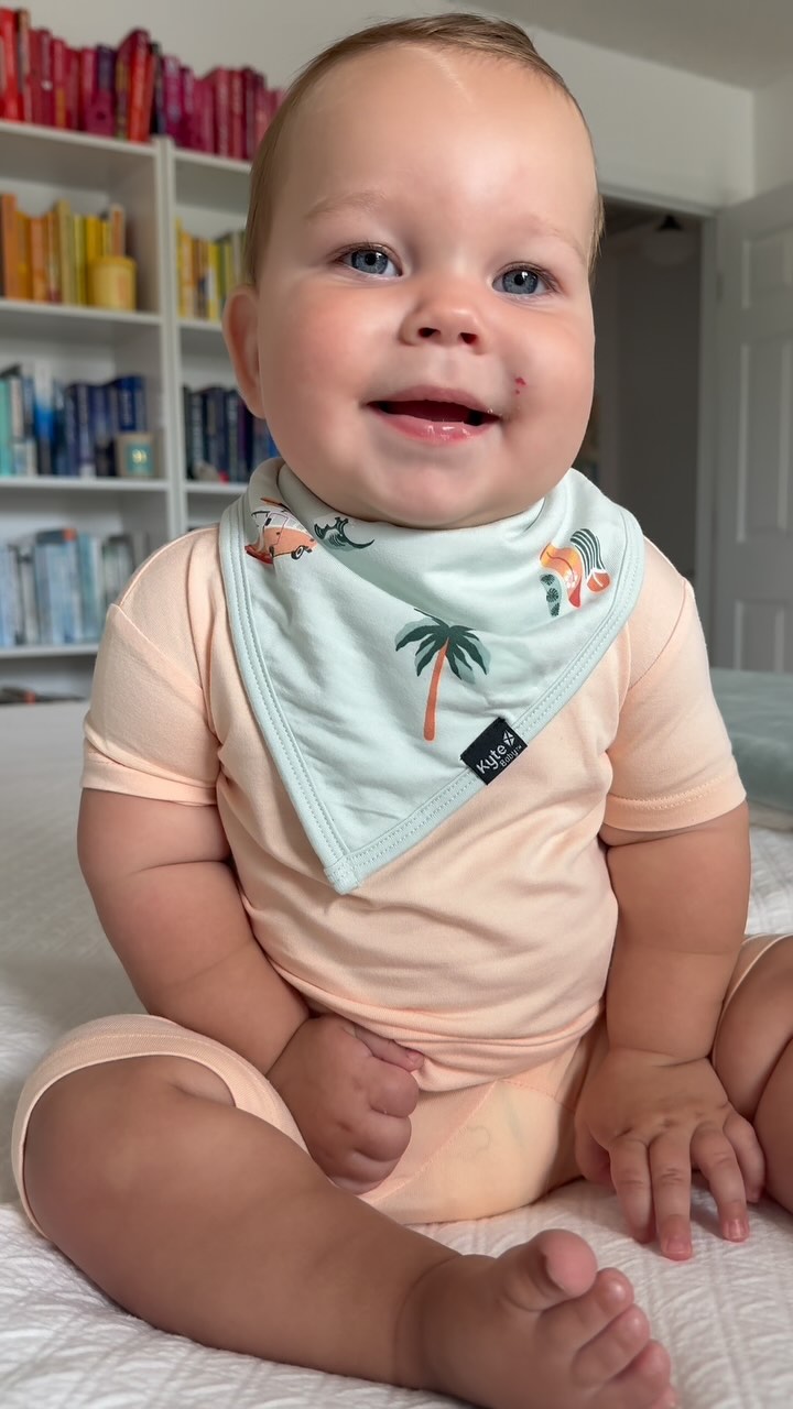 Instagram post by @bookswithbrielle for Kyte Baby. Caption reads: 𝐒𝐮𝐫𝐟’𝐬 𝐔𝐏! 🏄‍♂️🌊

Keeping my baby comfy....
