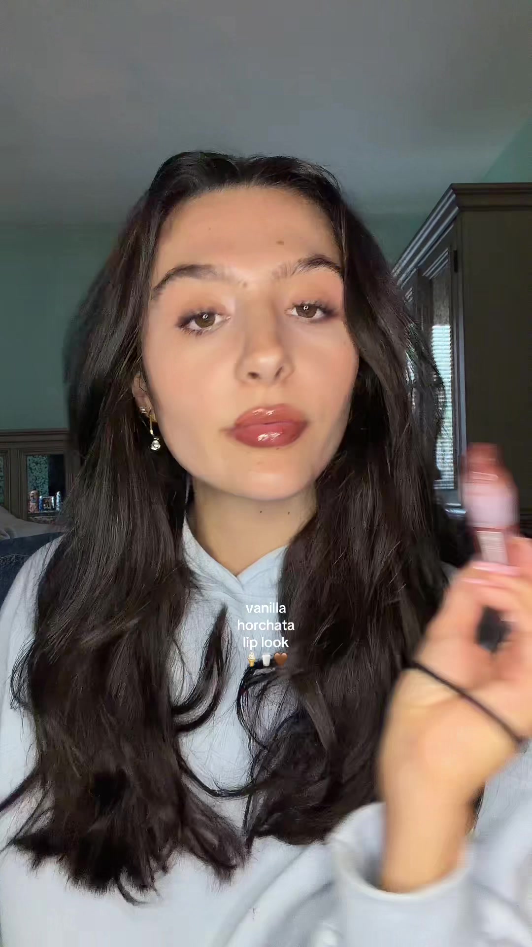 TikTok post by an influencer for Maybelline. Caption reads: [...] glass lips 🤩 thanks to @Maybelline NY....