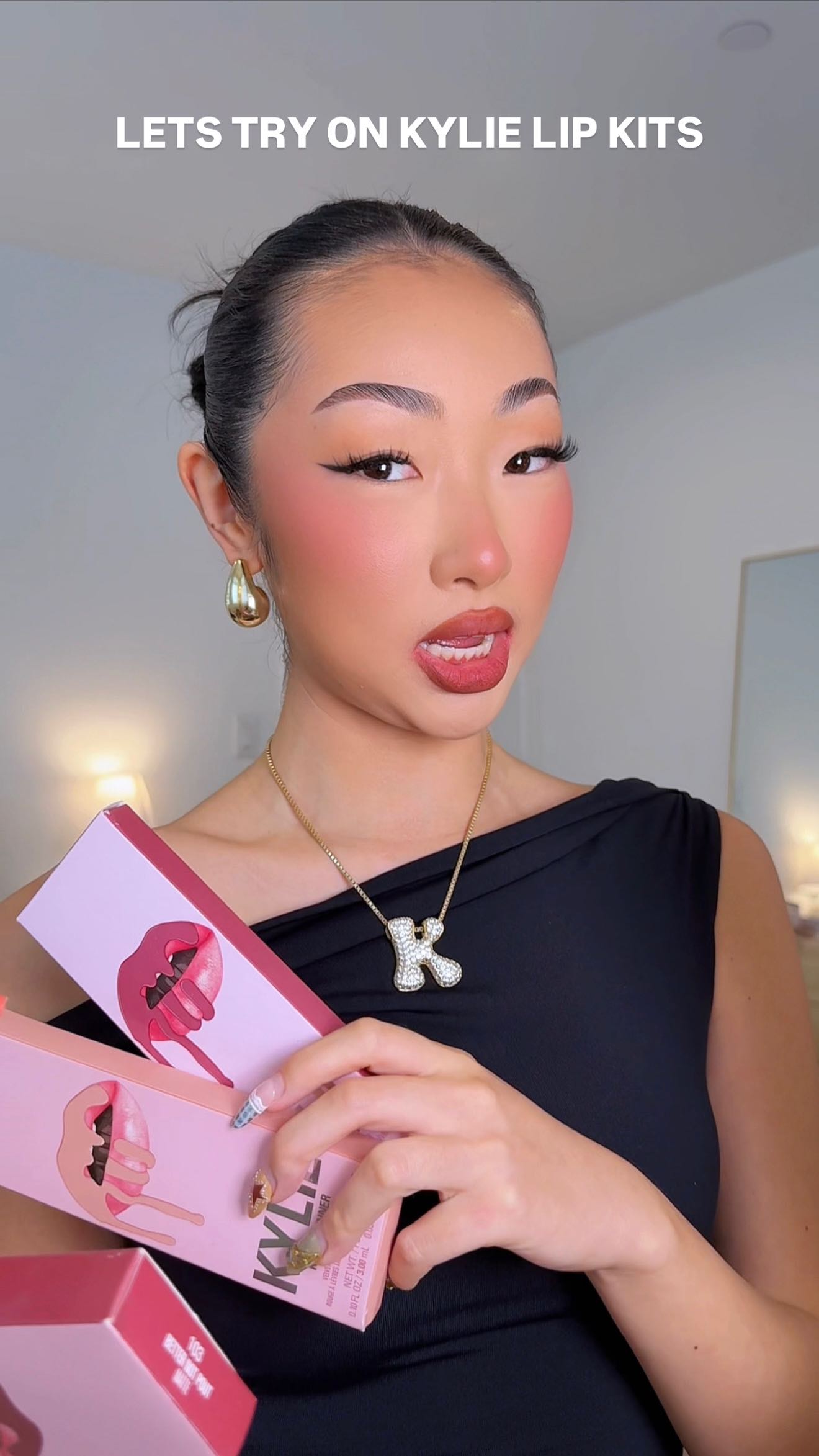 Instagram post by @itsbabykelz for Kylie Cosmetics. Caption reads: let’s try on some @kyliecosmetics lip kits ✨ kinda....