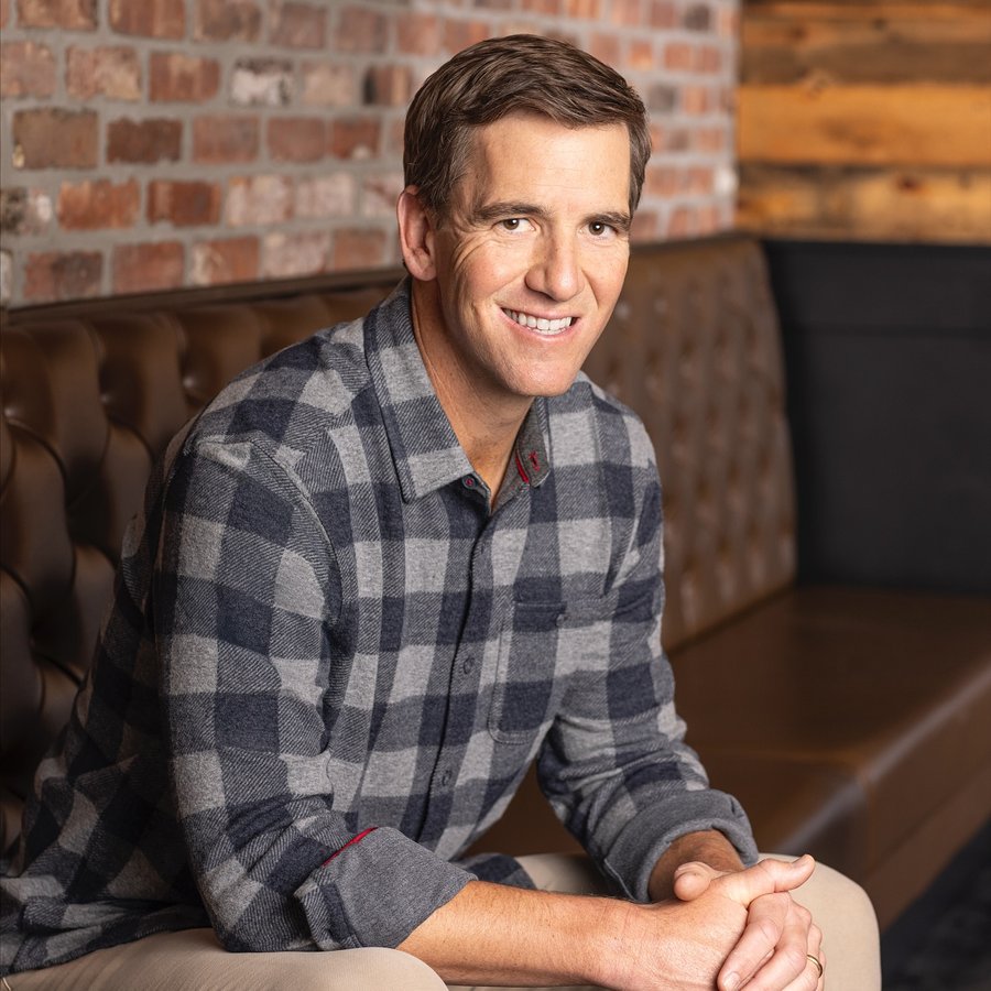 Instagram post by @elimanning for Flag & Anthem. Caption reads: On and off the field, Eli embodies the....