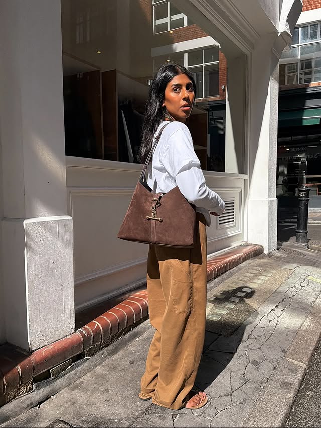 Instagram post by @monikh for Strathberry. Caption reads: Suede season with my Strathberry Kite Hobo....