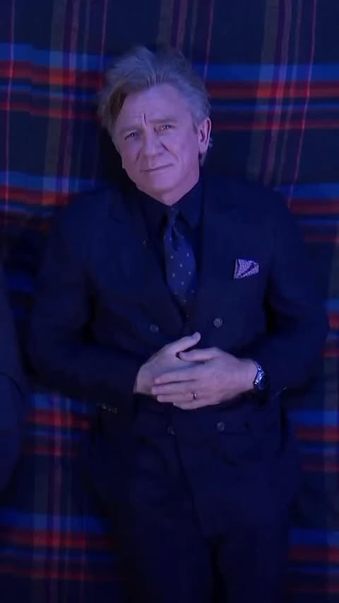 Instagram post by @whatsdanielwearing for OMEGA. Caption reads: Daniel Craig answers @stephenathome burning....