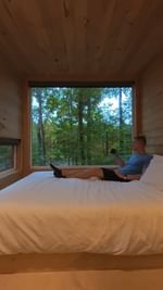 Instagram post by @asenseofhuber for Postcard Cabins. Caption reads: Giving tiny cabin life a spin. 🤎 Can confirm,....