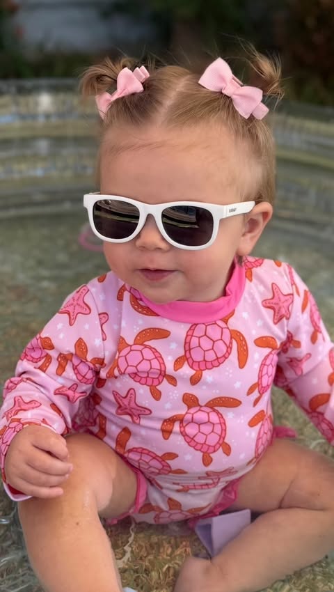 Instagram post by @littlelovebugstore for Polarised Baby Sunglasses. Caption reads: Hot days, little splashes and tiny sunnies doing....