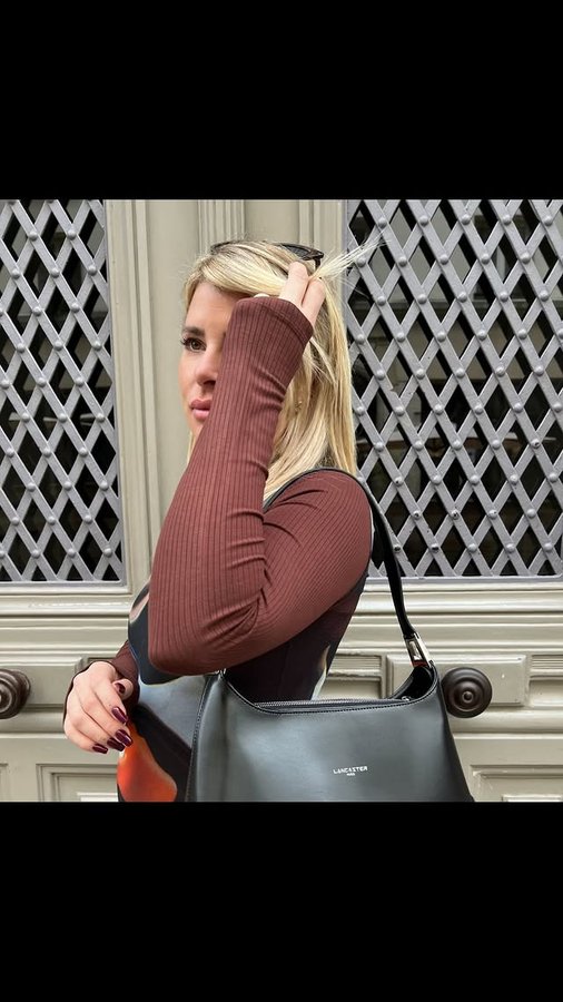 Instagram post by @emilie_fiorelli_officiel for Lancaster. Caption reads: New bag @lancaster 🖤 combo Robe @desigual....