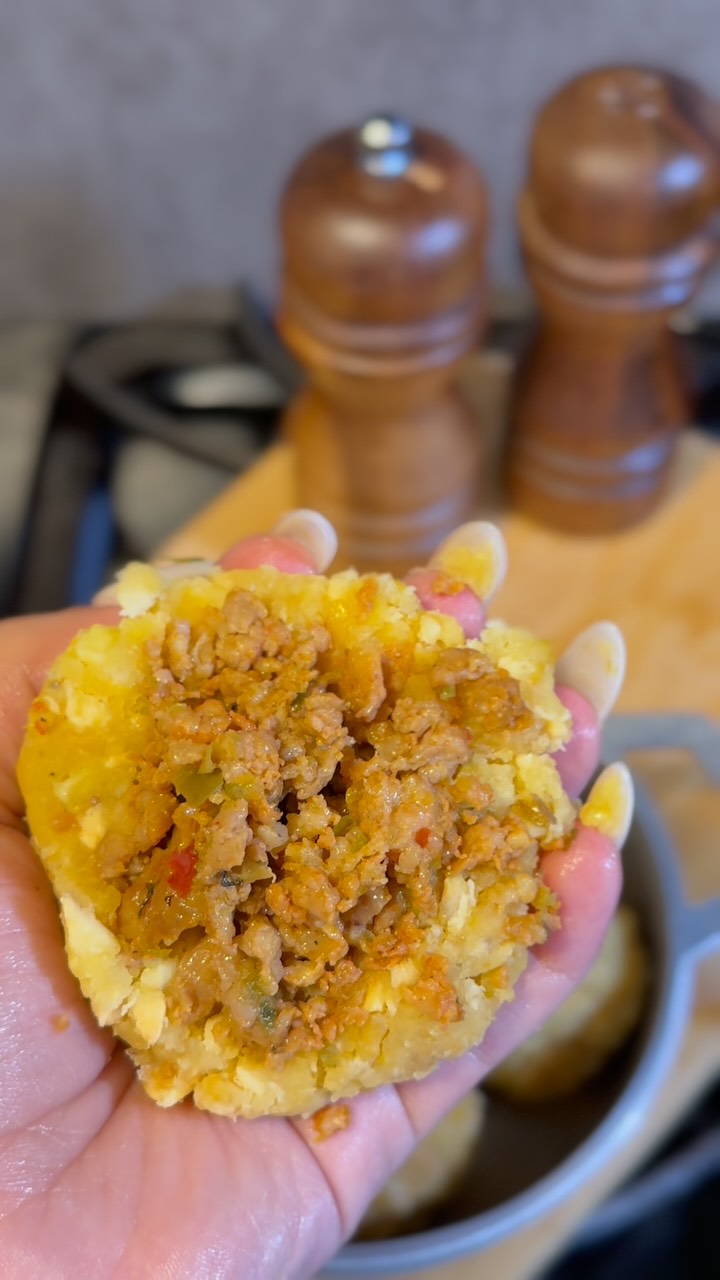 Instagram post by @cocina.newyorkina for Premio Foods. Caption reads: Mofonguito balls just leveled up! I stuffed them....