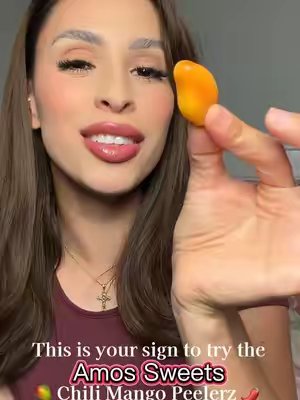 TikTok post by @kayycm for Amos Sweets. Caption reads: [...] this one! Chili mango peelerz from @Amos....