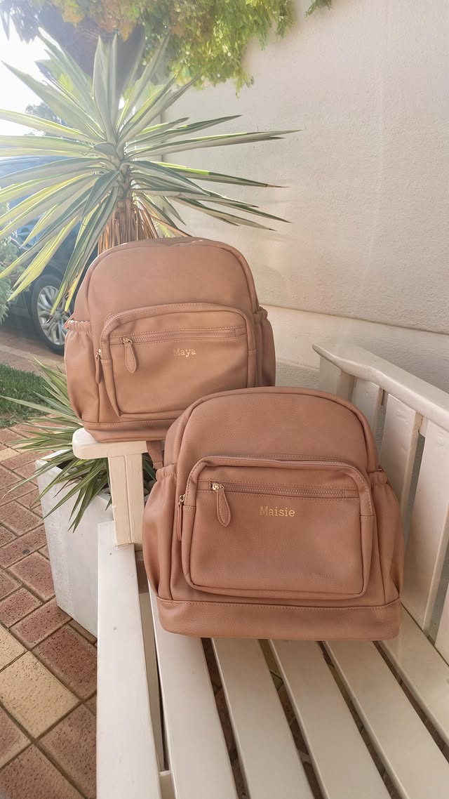 Instagram post by @wandermum_chelsea for Henlee. Caption reads: [...] of these personalised backpacks from....