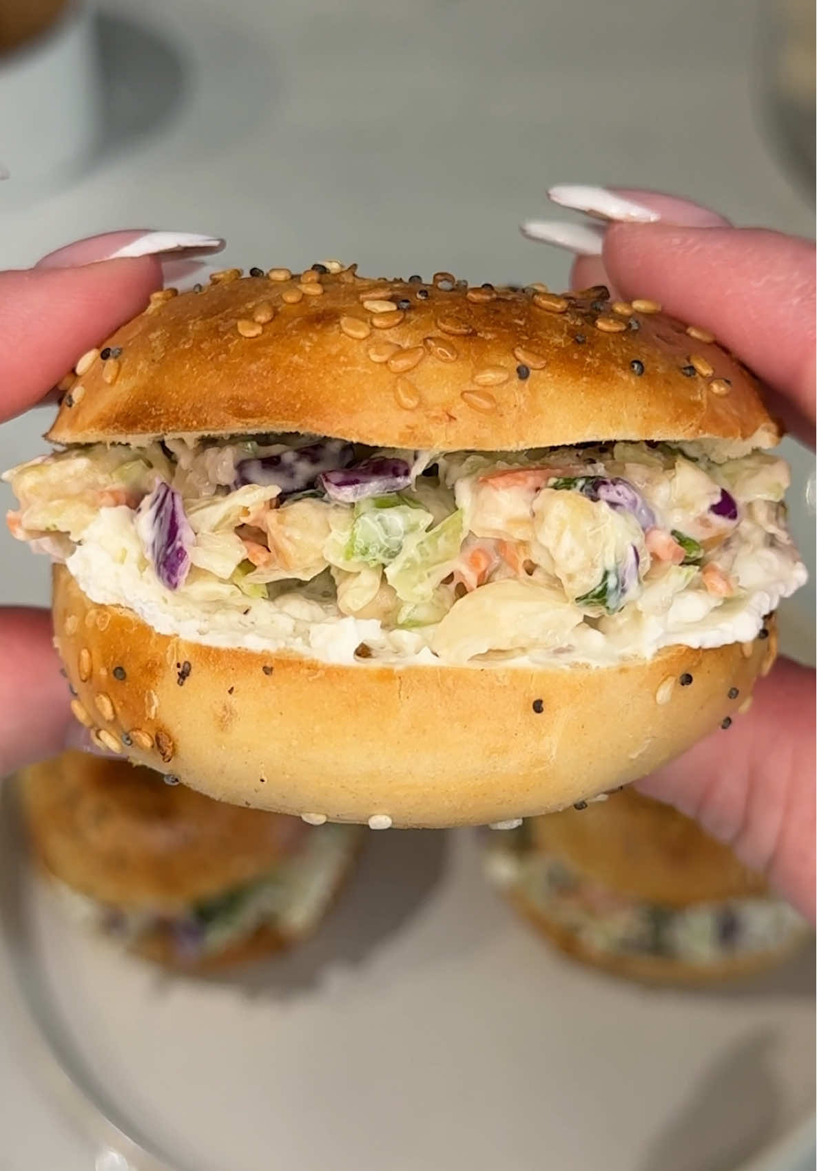 TikTok post by @ashleymarkleeats for Taylor Farms. Caption reads: [...] veggie boost 🥗🥯  Ingredients: @Taylor....