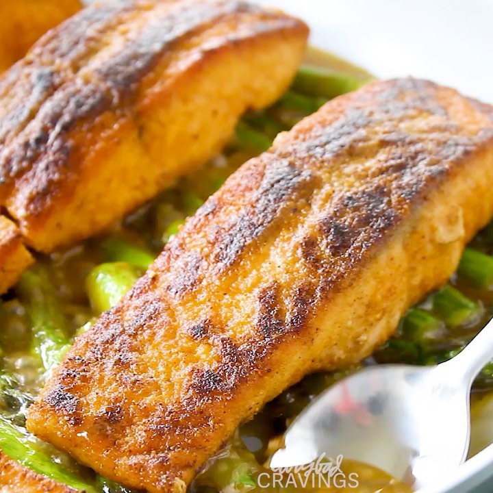 Instagram post by @carlsbadcravings for HuffPost. Caption reads: #ad SALMON AND ASPARAGUS bathed in Lemon Piccata....