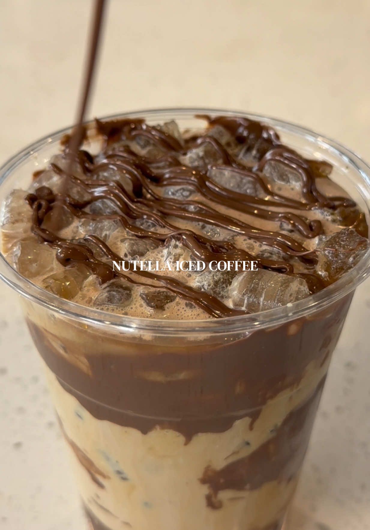 TikTok post by @stephanienunez_ for Everyday Dose. Caption reads: Nutella iced coffee 😍🤎☕️🍫 find everyday dose at....