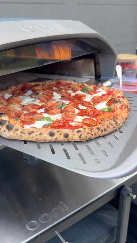 Instagram post by @eddiespizza412 for Ooni. Caption reads: Launching pizzas with my NEW @oonihq Signature....