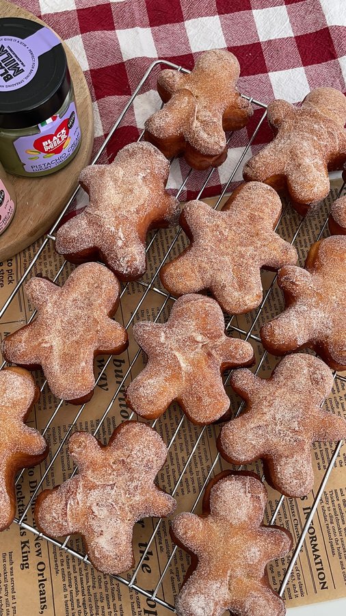 Instagram post by @sophsgoodies for Black Milk. Caption reads: Gingerbread Men Shaped Donuts stuffed with....