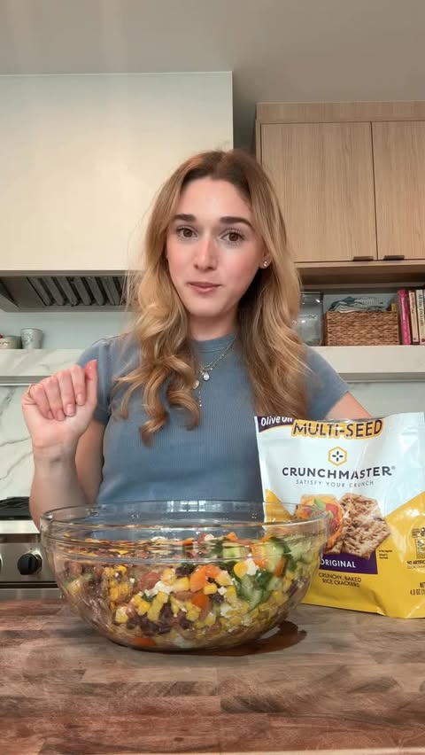 Instagram post by @thedailyschvitz for Crunchmaster Crackers. Caption reads: [...] satisfying crunch every time....