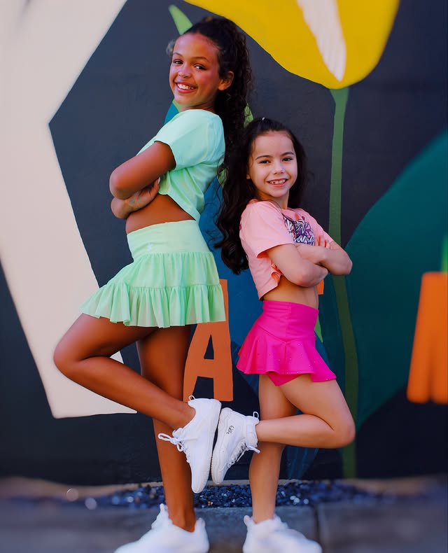 Instagram post by @aubreebedoya for Rebel Athletic Women. Caption reads: Back to back & stronger together 💚💖✨ Standing....