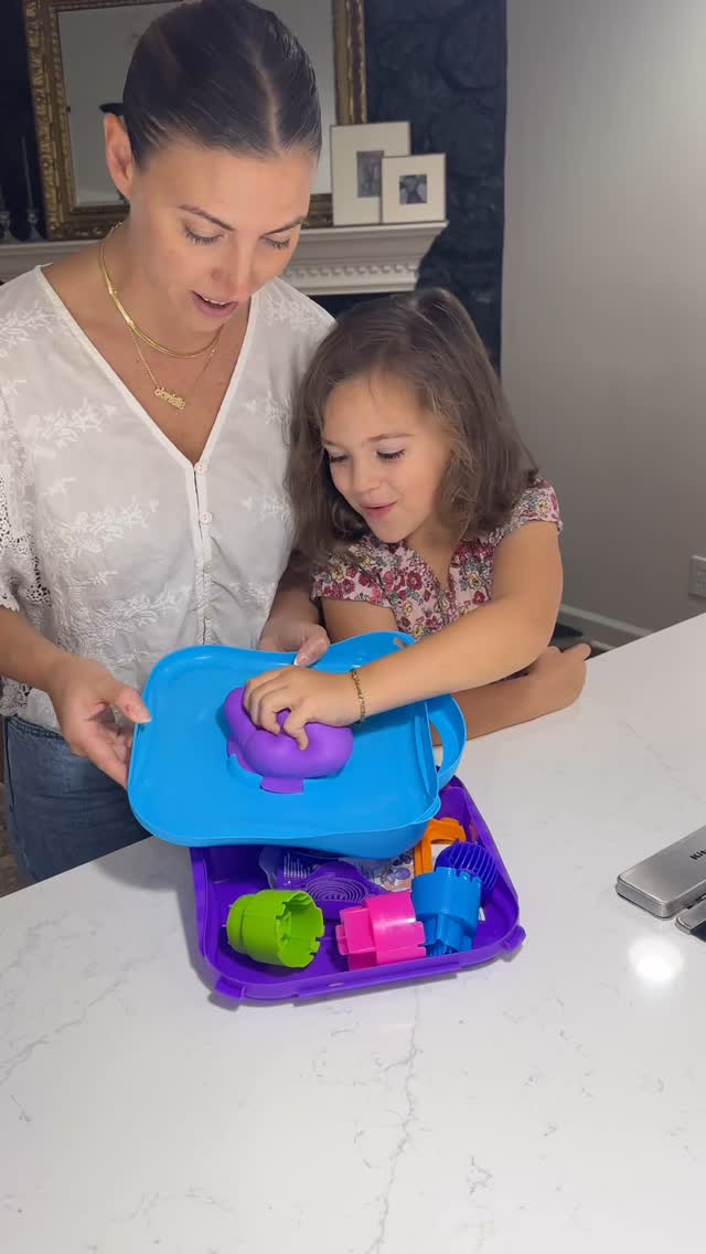 Instagram post by @daniellepiercee for Kinetic Sand. Caption reads: Watching my daughter get lost in her own world....