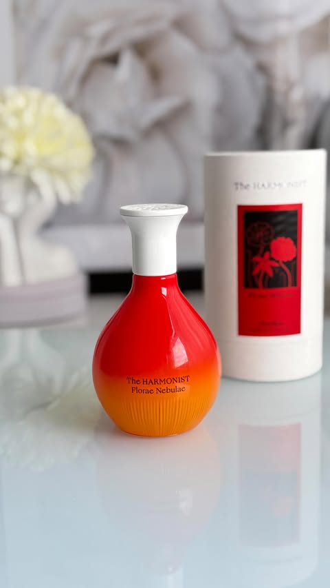 Instagram post by @bossbabestace for The Harmonist. Caption reads: Florae Nebulae🧡✨✨ @theharmonist This fragrance....