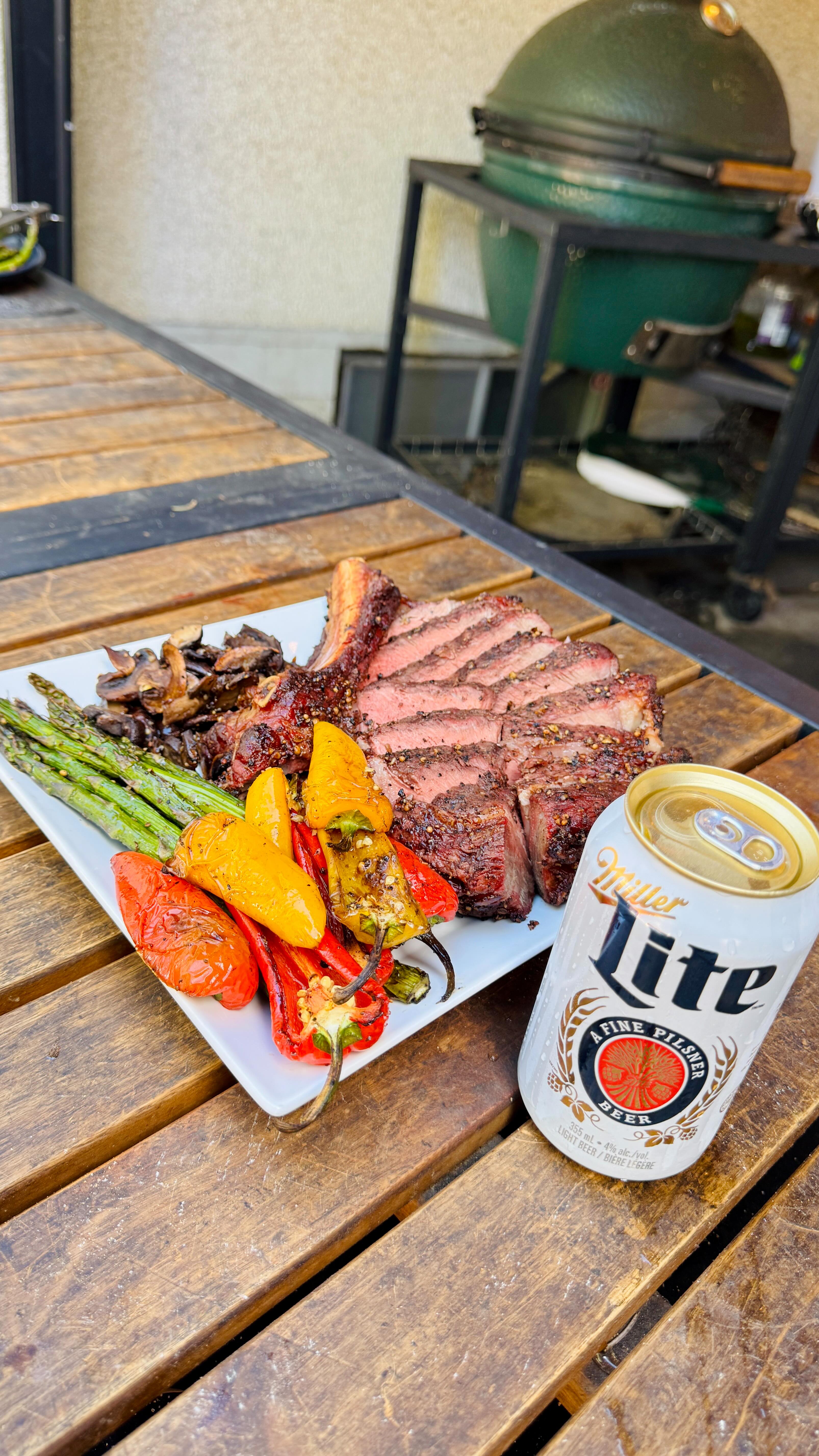 Instagram post by @darksideofthegrill for Miller Lite. Caption reads: A thick Ribeye Flame seared to perfection with....